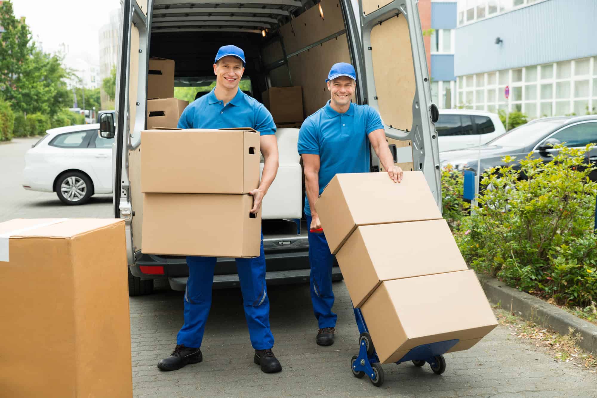 Workers loading cardboard boxes into a moving truck
